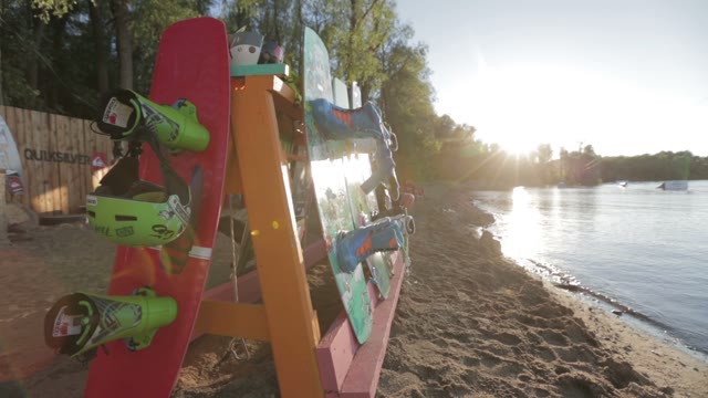 Stand With Wakeboard On The Background Of The Lake, Sunset, Trees.