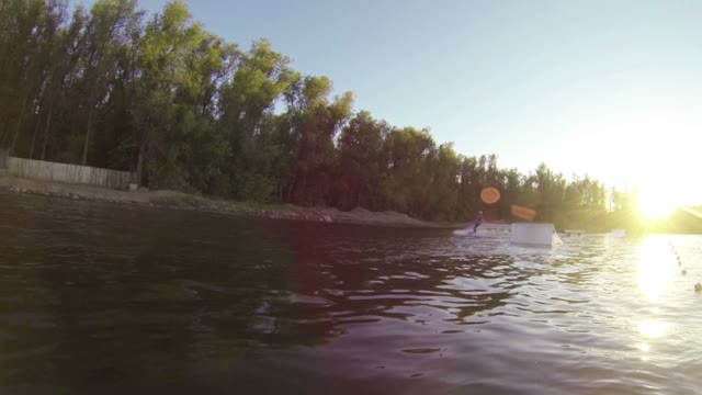 Man Does Extreme Stunts On A Wakeboard In Slow Motion On The Lake