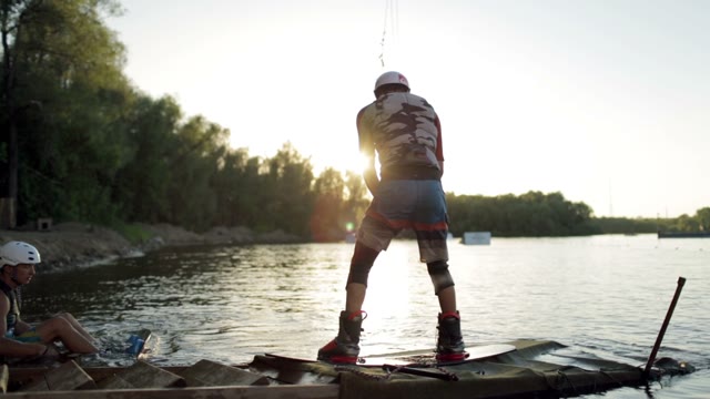 Wakeboarder In Protection Shoes Start Action On The Board
