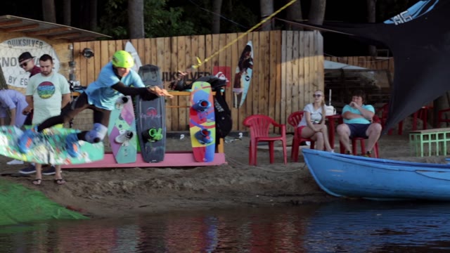A Young Man Begins To Ride A Wakeboard.