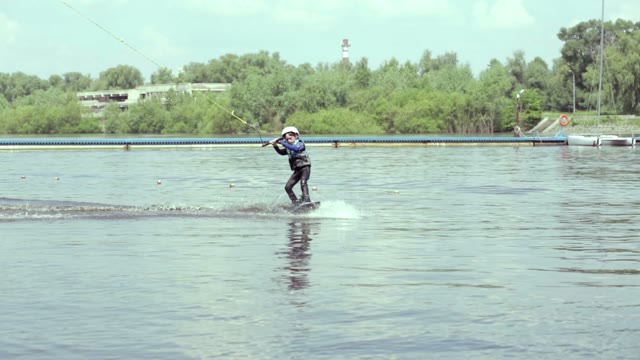 Little Boy Riding A Wakeboard In The Park