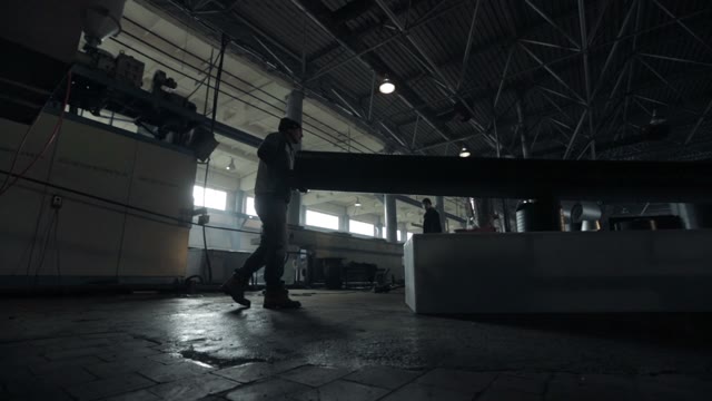 A Man Working At Pipe Rolling Plant. Transfers Pipe.