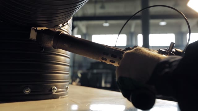 A Man Working Industrial Soldering Gun. Close-up