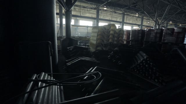View Of The Warehouse With Pipes, Pallets, Barrels And Various Tools