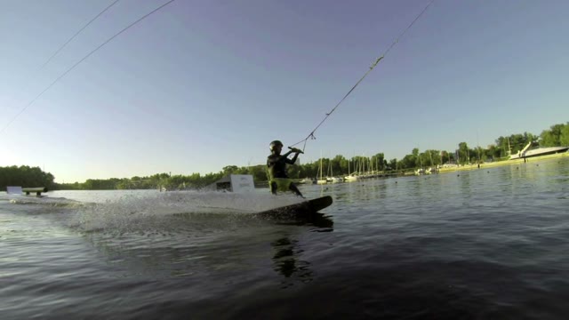 Young Boy Doing Tricks On A Wakeboard. Slow Motion.