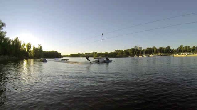 The Guy Doing Tricks On A Wakeboard In Slow Motion On The Lake.