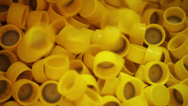 Production Of Plastic Bottle Caps. Close-up.