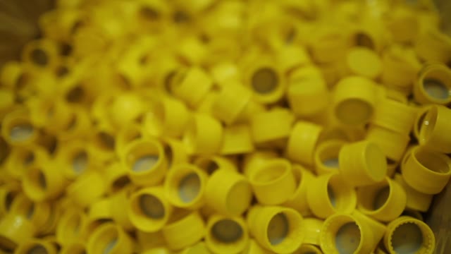 Many Yellow Plastic Bottle Caps, Close-up.