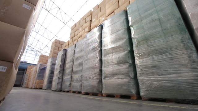Forklift With Boxes Going At An Industrial Warehouse