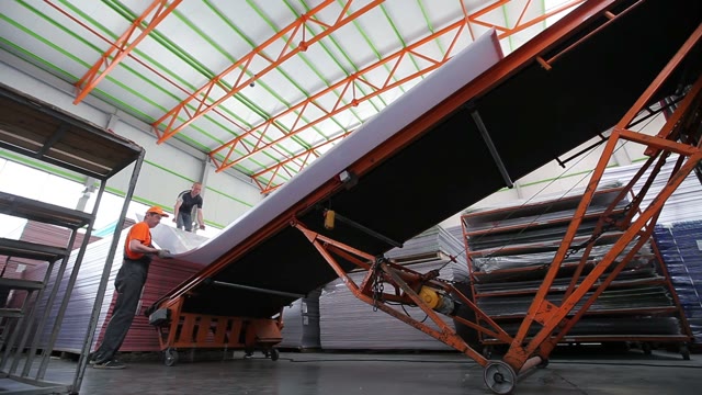 Workers Loaded Polycarbonate Sheets To The Tape