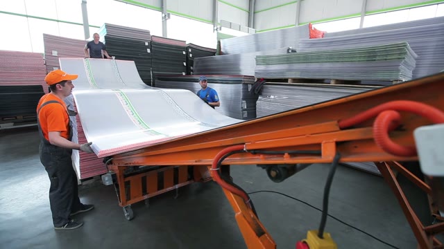 Workers Loaded Polycarbonate Sheets In The Truck. Close-up Of Loading Tape
