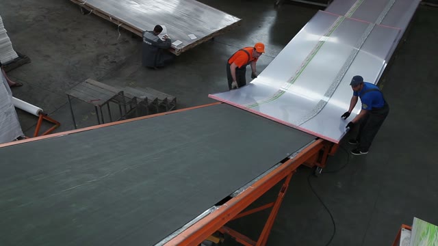 Workers Loaded Polycarbonate Sheets To The Tape
