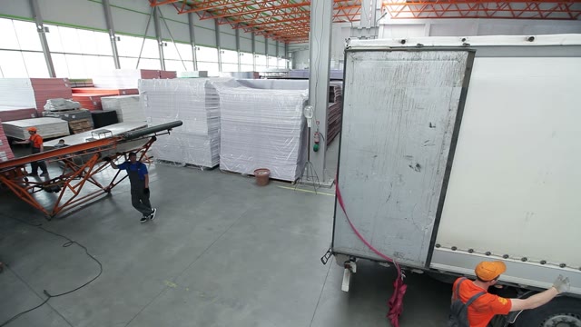 Truck Pulls Up To The Loading Belt In The Hangar