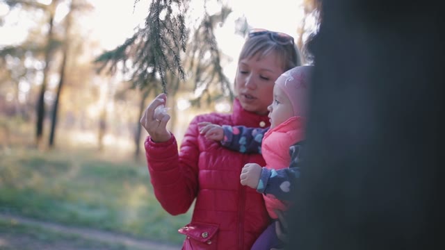 Autumn In The Park, Mother Holding A Child In Her Arms.
