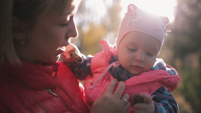 Mother Keeps Child In Her Arms. Close-up. Light Of The Autumn Sun.
