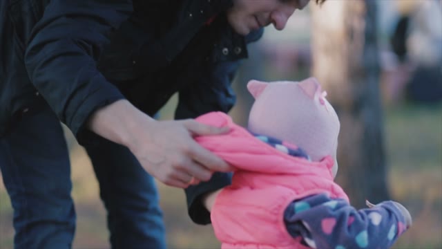 The Father In The Autumn Forest Helps Children Take The First Steps