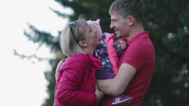 Happy Family Hug. The Child In Her Arms.