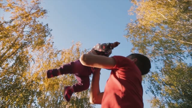 Happy Father Throws His Little Daughter To The Sky.