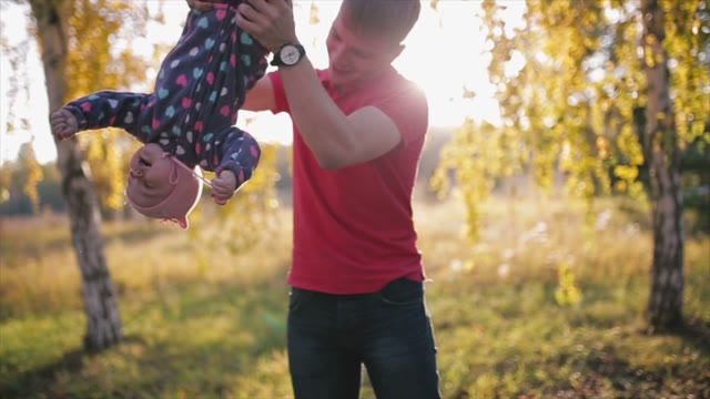 The Father Hung The Child's Legs, Then Put On The Ground.