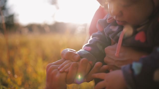 Mom, Dad And Daughter Hold Hands. Happy Family In Autumn Park.