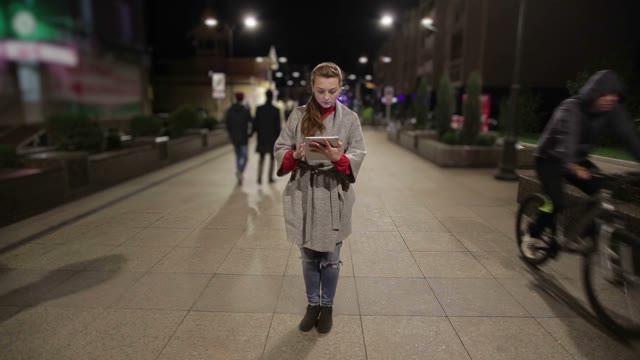 Girl In Real Time Using Tablet On The Streets, That Stopped In Time.