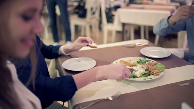 Young People In The Restaurant Eating.