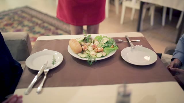 On The Table In The Restaurant Is A Plate With Vegetables And Bread. Close-up.