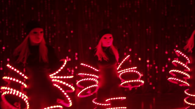 Girls Dancing In Luminous Costumes