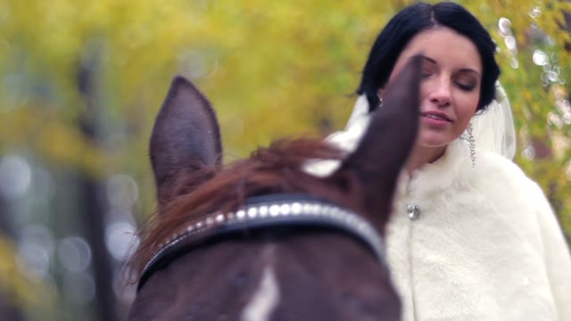 Bride Sitting On A Horse And Smiling.
