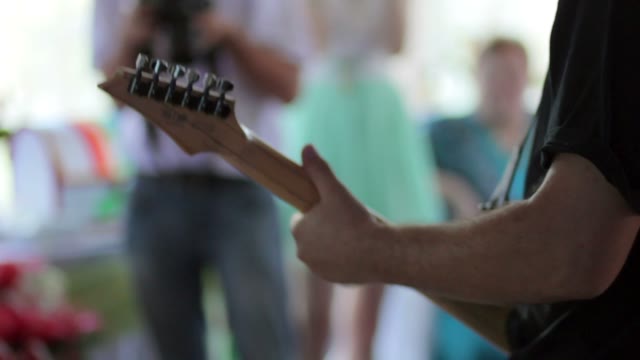 The Man Playing The Guitar At The Festival. View From Back.
