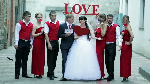 The Bride And Groom And Their Friends Posing For The Camera At The Wedding.