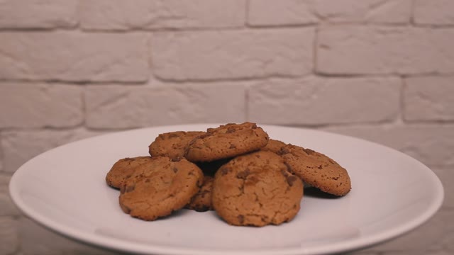 Chocolate Cookies Rotating On A White Plate