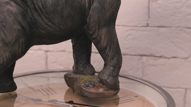 Figure Of Elephant Standing On A Rotating Clock