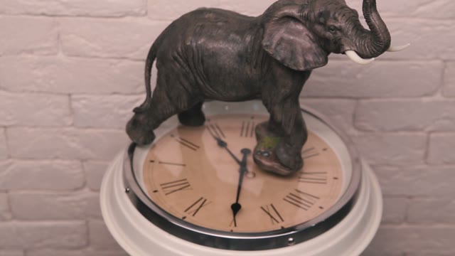 Figure Of Elephant Standing On A Rotating Clock