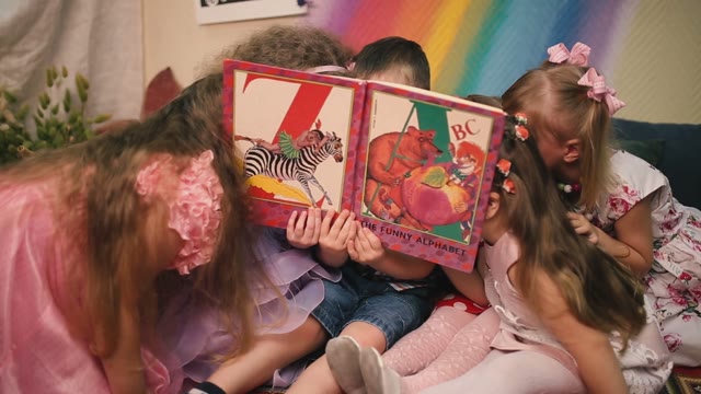 Kids Hiding Behind A Book. Suddenly Clean It And Laugh.