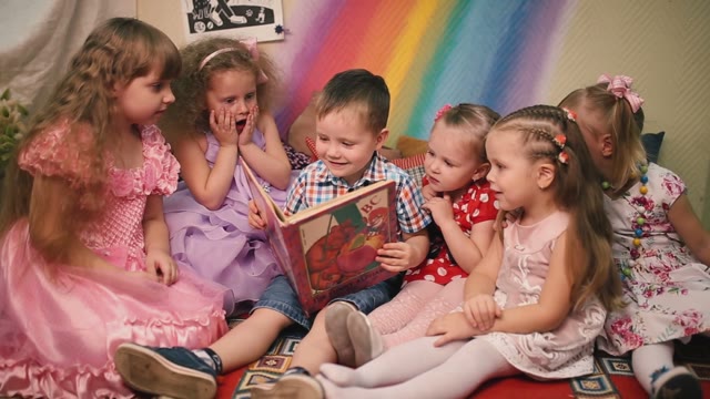 Children Sit And Look At Books.