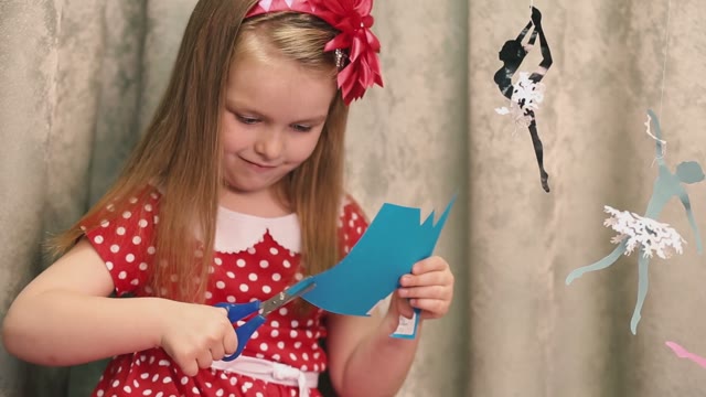Girl In Red Cut Cardboard With Scissors