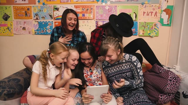 Young Girls Looking At Tablet And Laughing