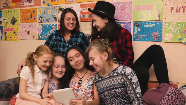 Children Chat And Play With The Tablet.
