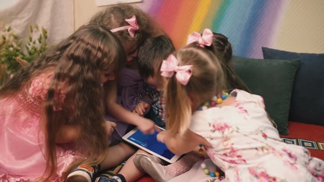 Small Children Play With The Tablet.