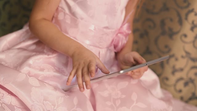 Little Girl Thumb Drives On The Tablet.