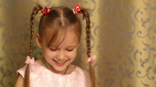 Little Girl With Pigtails Smiles Sweetly.