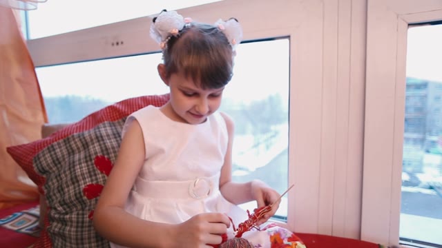 Little Girl Smiles And Enthusiasm Makes Crafts.