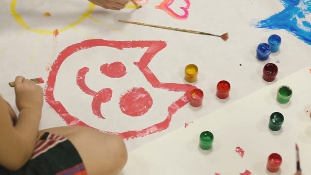 Little Girl Draws Paints On A Canvas On The Floor Of Cats.