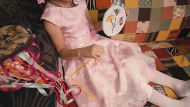 Little Girl Holding A Hand-made Article.