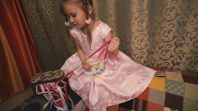 Cute Little Girl In The Basket Gets Tangled Colored Ribbons.