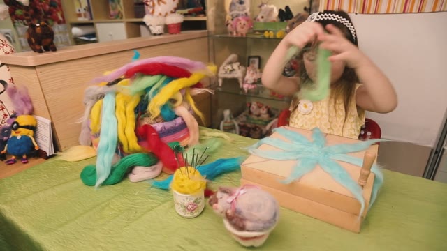 The Little Girl Puts Scraps Of Colored Wool.