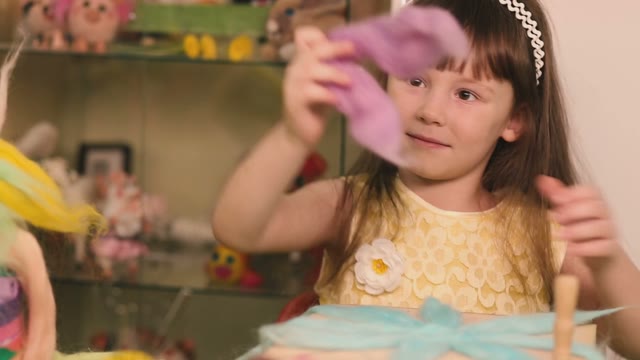 Little Girl Decorates Her Pink Wool Crafts.