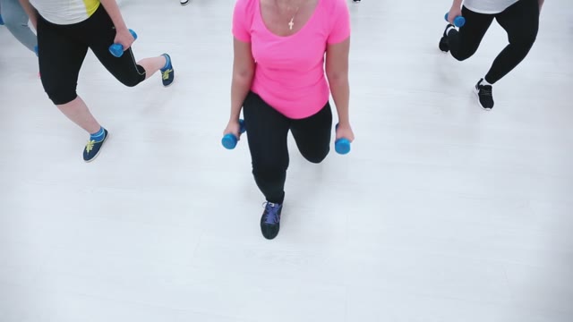 Girls In Sportswear Squat With Dumbbells During Training Fitness.