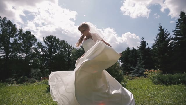 Bride In Wedding Dress Spinning On The Grass.